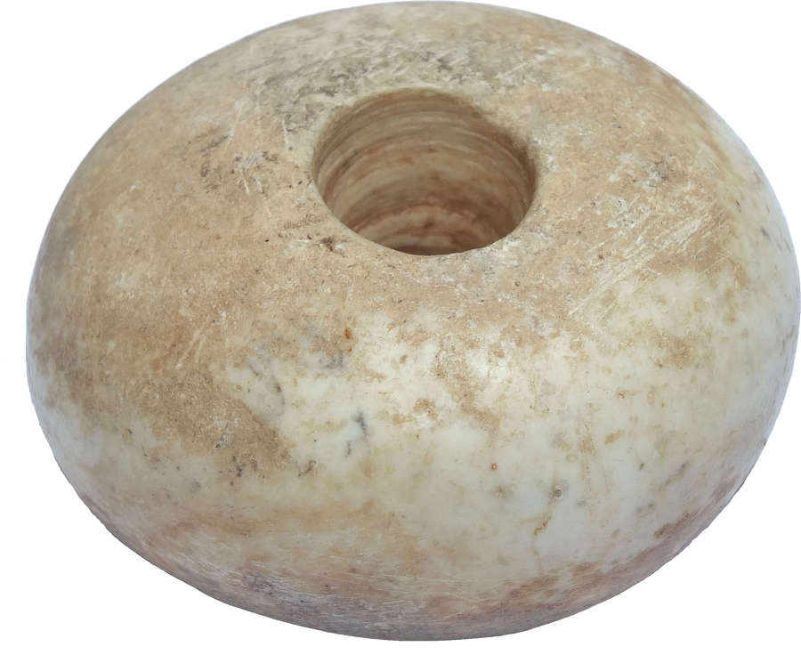 An Egyptian marble doughnut-shaped macehead, c. 4000-3000 B.C.