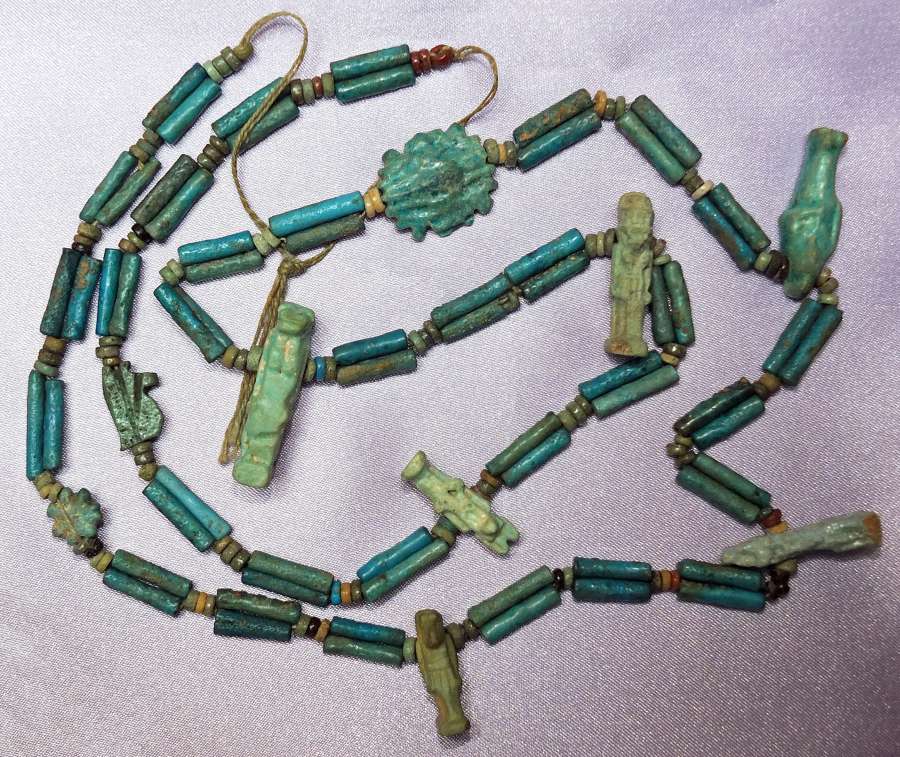 An Egyptian restrung amuletic blue faience bead necklace