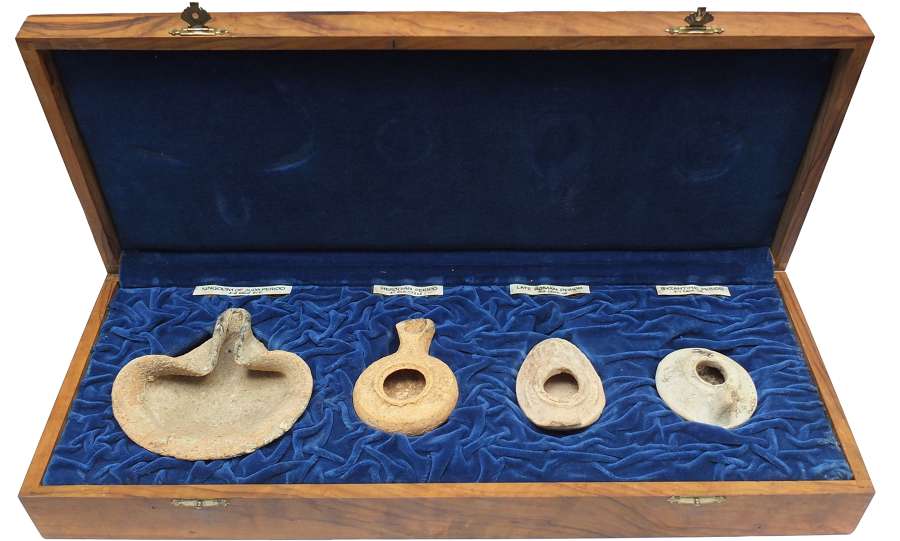 Four ancient pottery lamps from Israel presented in an olive wood box