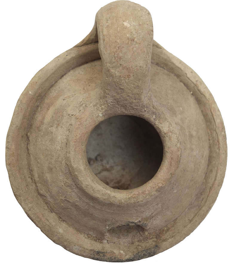 A circular early Islamic pottery oil lamp, c. 8th - 10th Century A.D.