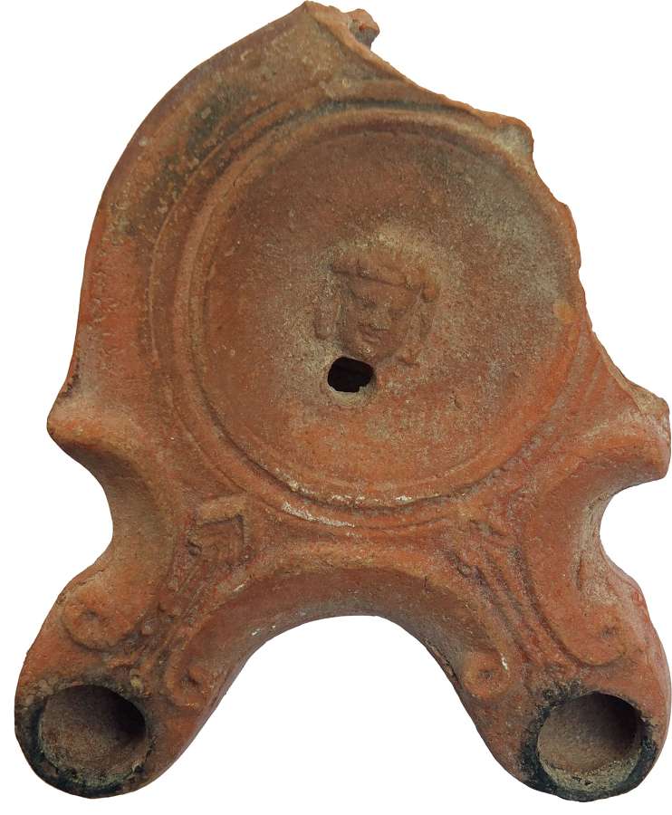 A Roman twin-nozzle red-slipped pottery oil lamp, c. 60-100 A.D.