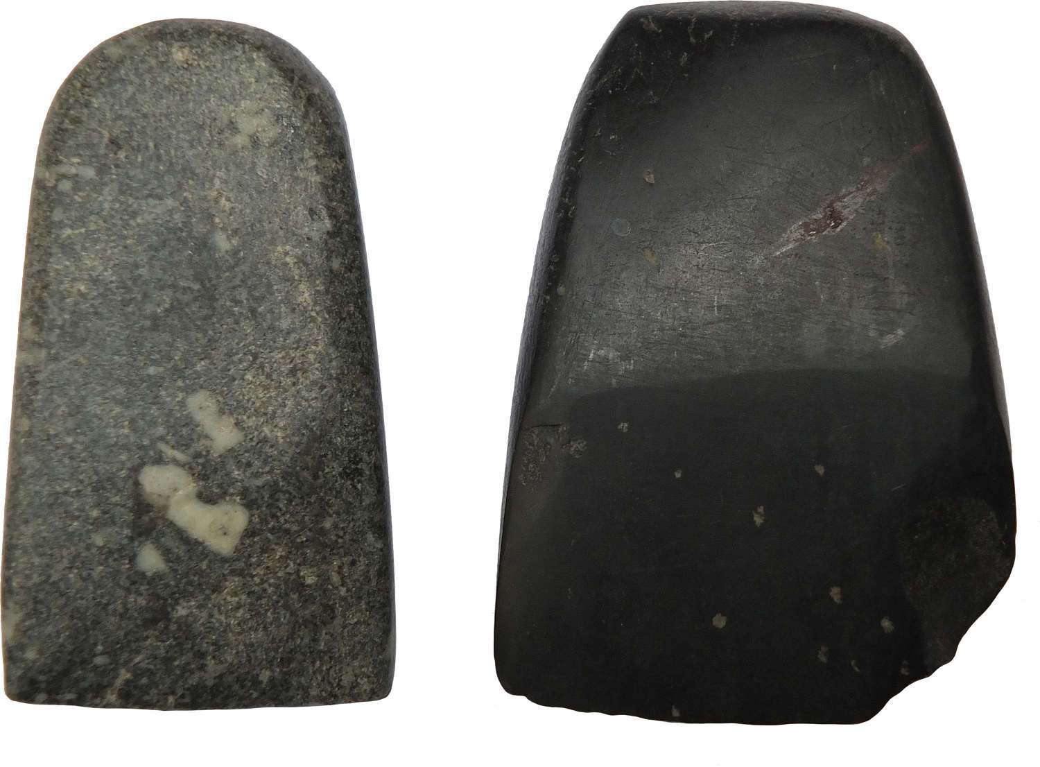 Two small dark stone polished axeheads