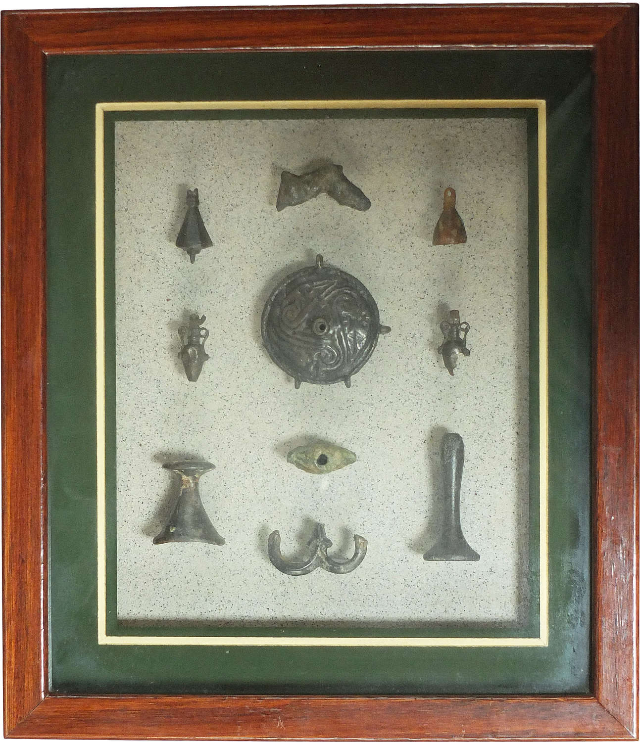 A framed group of ten Roman bronze fittings and attachments