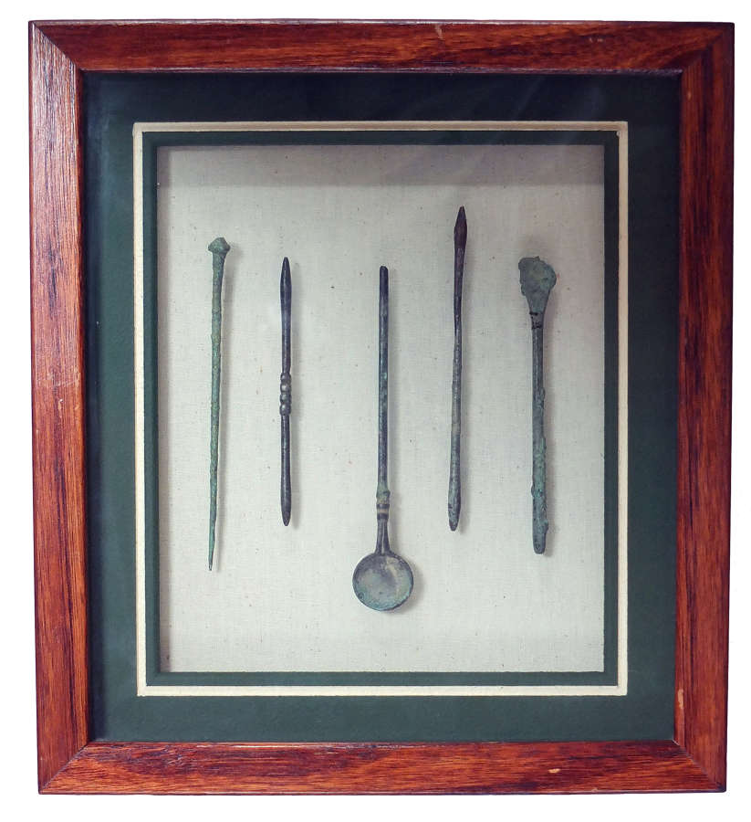 A framed group of five Roman medical/cosmetic tools