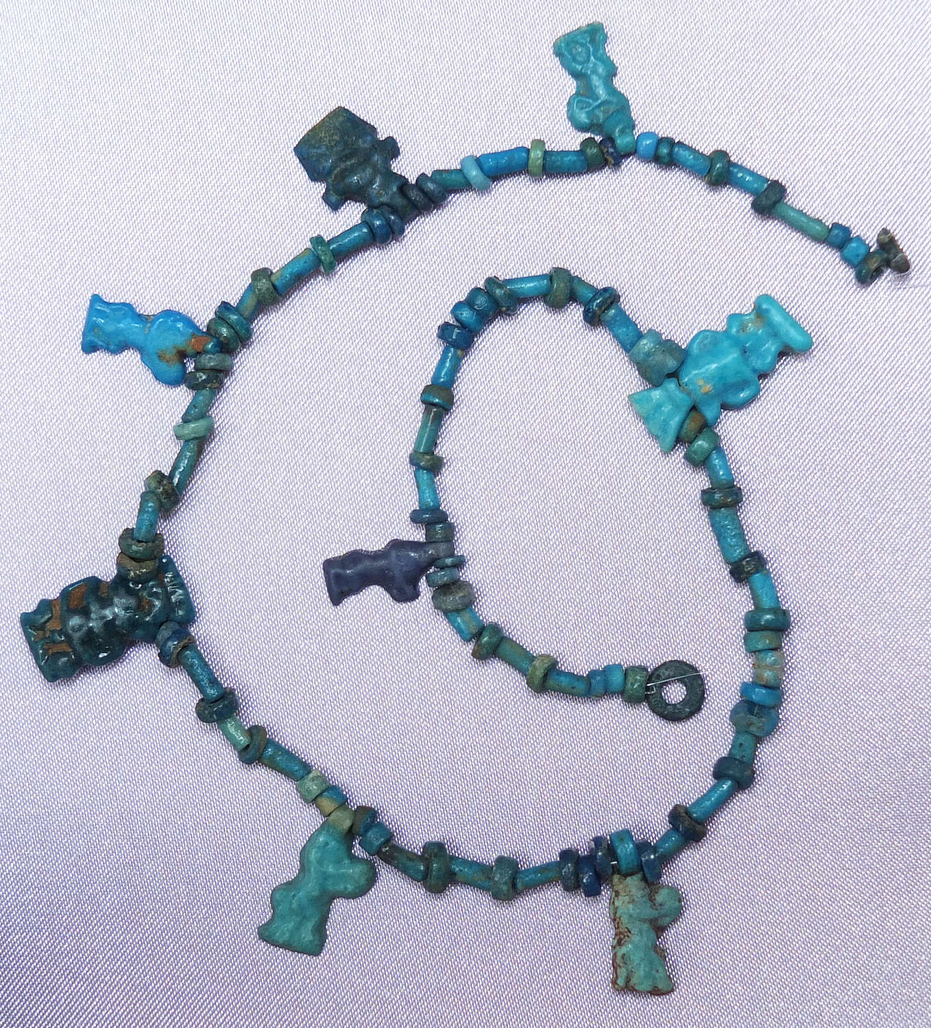 A length of ancient Egyptian beads with Amarna Period Bes pendants