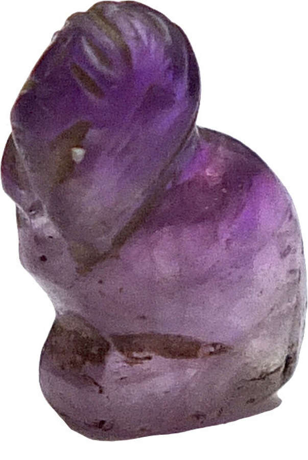 A small amethyst amulet of a crouching sphinx, c. 2055-1650 B.C.