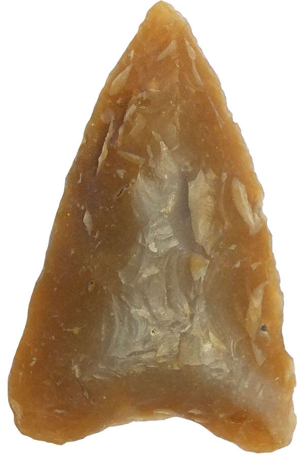 A triangular mottled brown flint hollowbase arrowhead