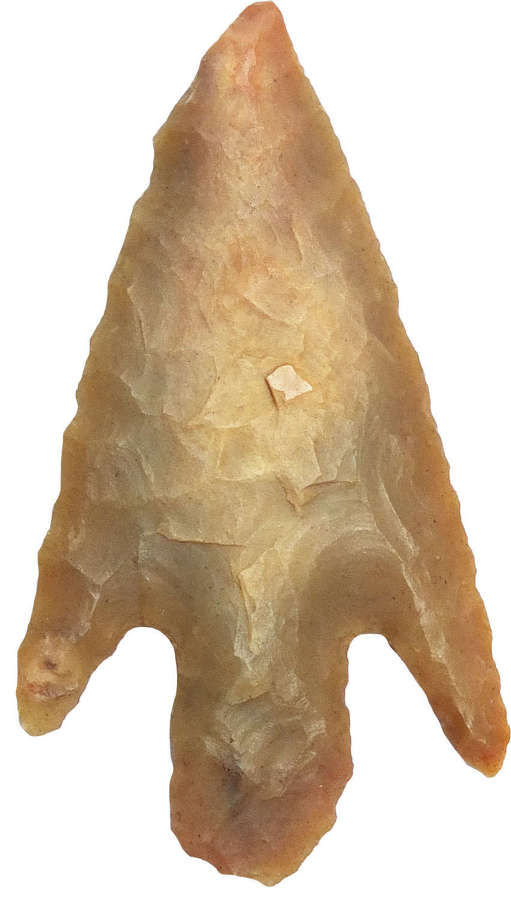 A Neolithic - Early Bronze Age barbed-and-tanged brown flint arrowhead