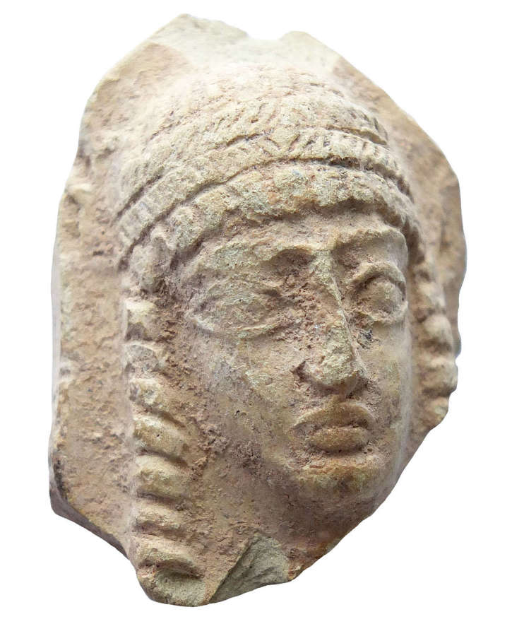A Near Eastern terracotta head of a goddess, c. 1st Millennium B.C.