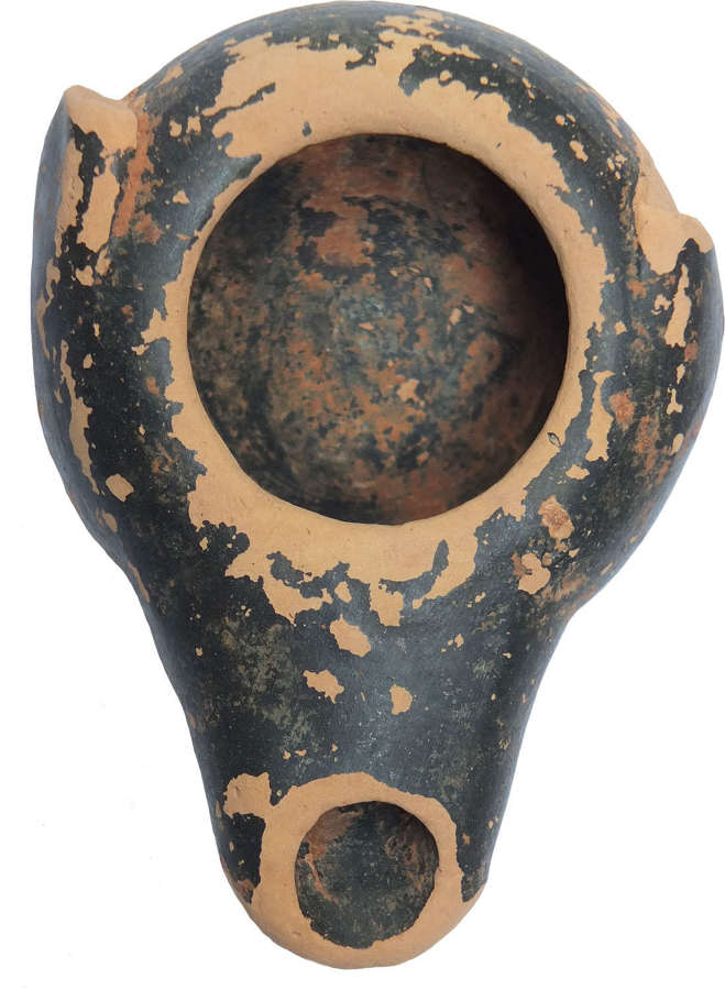A Greek black-slipped pottery oil lamp, c. 4th Century B.C.