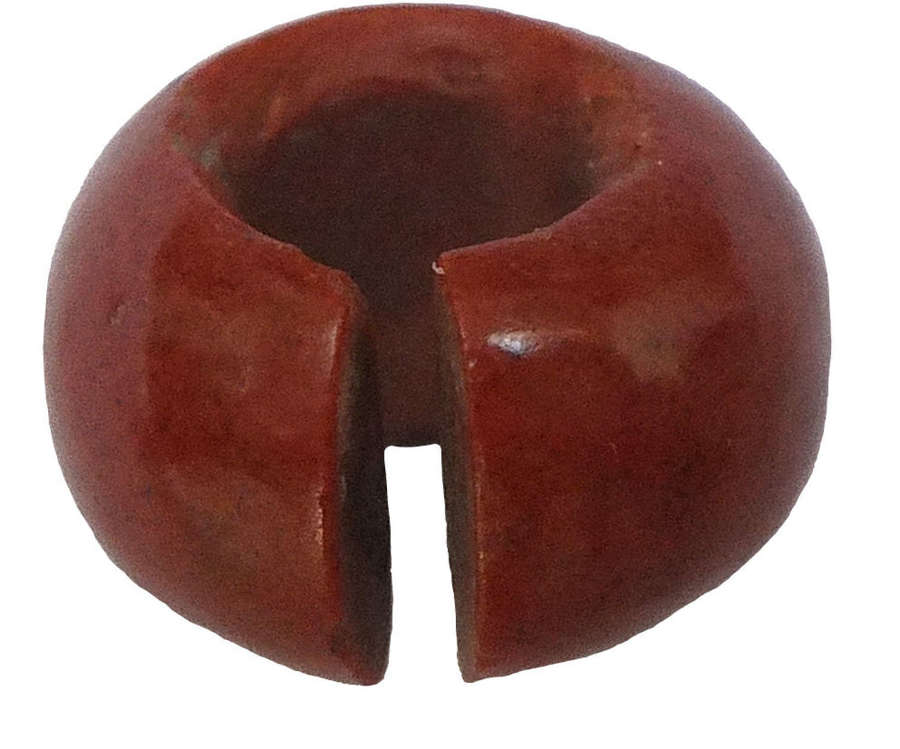 An Egyptian red glass hair ring, imitating jasper, c. 1550-1069 B.C.