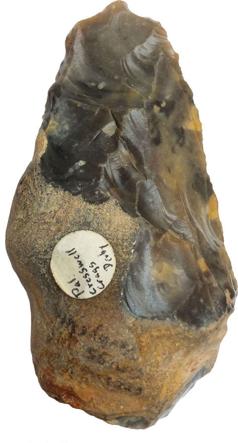 A Palaeolithic grey flint handaxe labelled Creswell Crags, Derbyshire