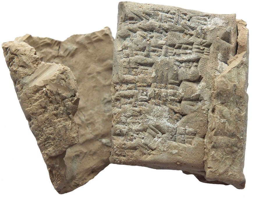 A Sumerian cuneiform clay tablet with envelope, 2200-1900 B.C.