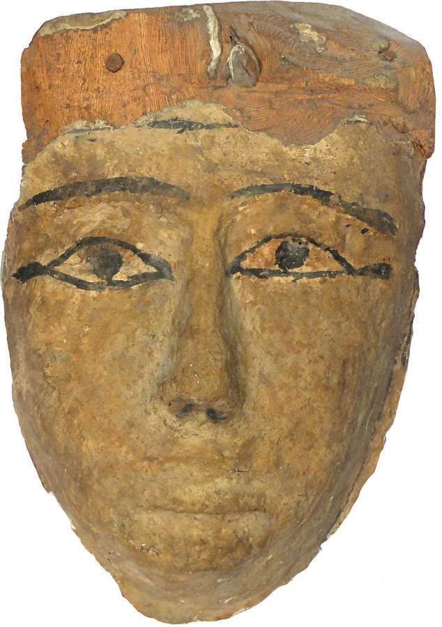 An Egyptian wooden mummy mask, 1st Millennium B.C.